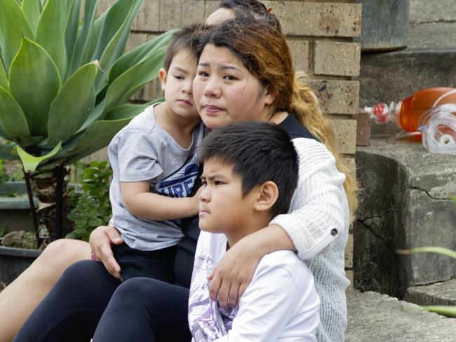 Relatives of Henry Tran, 2, at his Fairfield home where he was found in a pond. Picture: Jenny Evans