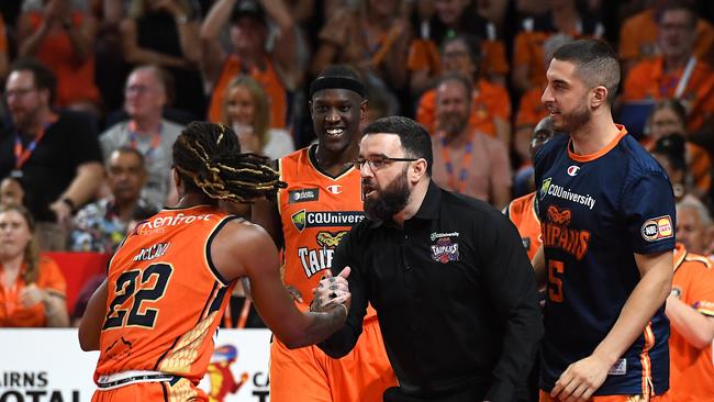 Taipans head coach Adam Forde helps up Tahjere McCall. (Photo by Albert Perez/Getty Images)