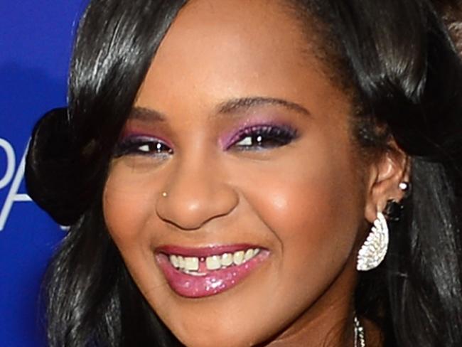 (FILES) - A file picture taken on August 16, 2012, Bobbi Kristina Brown arrives at Tri-Star Pictures' "Sparkle" premiere at Grauman's Chinese Theatre in Hollywood, California. Bobbi Kristina Brown, the only child of pop legend Whitney Houston and singer Bobby Brown, died July 26, 2015 aged 22, six months after she was found unconscious in a bathtub in her home. "She is finally at peace in the arms of God. We want to again thank everyone for their tremendous amount of love and support during these last few months," a short family statement said, adding she was surrounded by loved ones as she slipped away. Bobbi Kristina -- sole heir to Houston's estate -- was discovered face down and unresponsive in her bathtub in her Atlanta, Georgia home on January 31. AFP PHOTO / Frederic J. BROWN