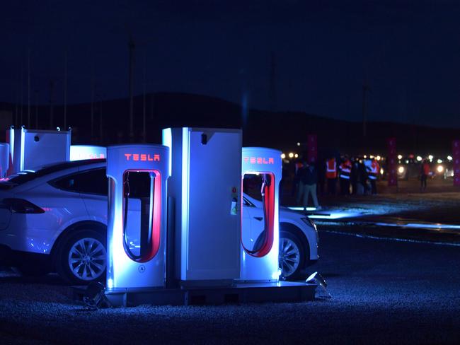 A Tesla car is seen charging at a Tesla charging station at the wind and solar battery plant outside of Jamestown. AAP Image/ Morgan Sette