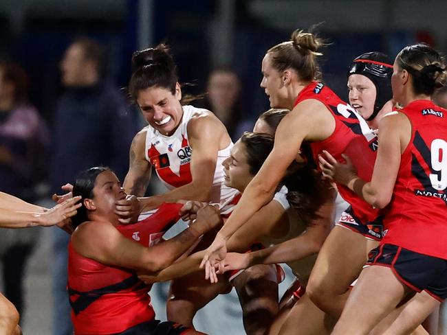 MELBOURNE, AUSTRALIA - OCTOBER 02: Players wrestle at the three quarter time siren during the 2024 AFLW Round 06 match between the Essendon Bombers and the Sydney Swans at Mission Whitten Oval on October 02, 2024 in Melbourne, Australia. (Photo by Michael Willson/AFL Photos via Getty Images)