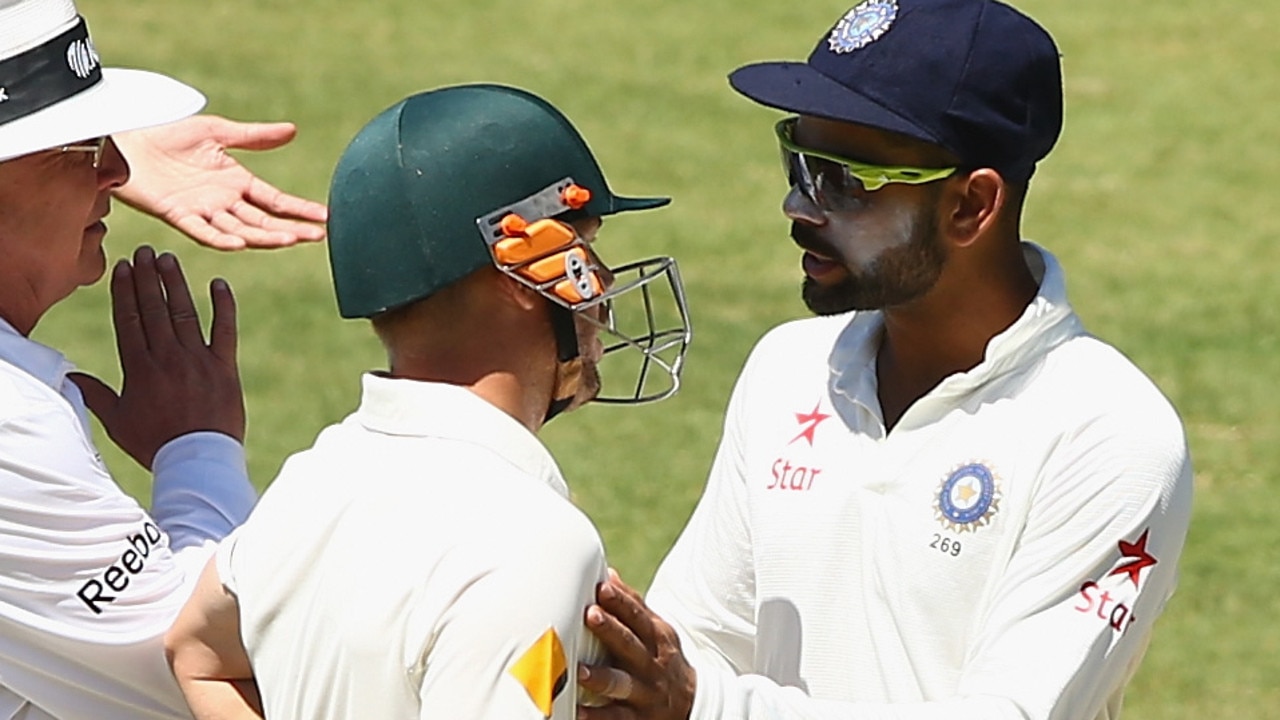 Virat Kohli of India and David Warner of Australia confront each other.