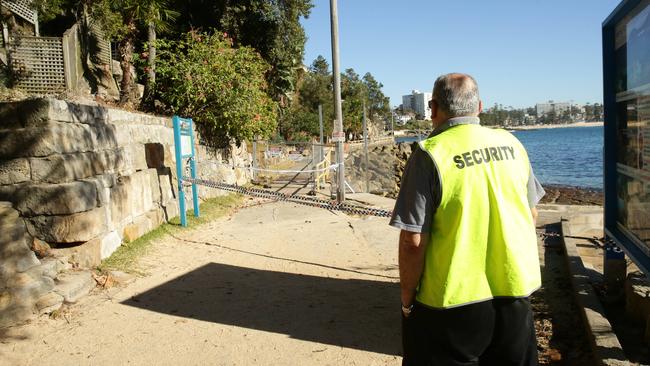 A security guard at Shelly Beach, where a new 3m high fence will go up.