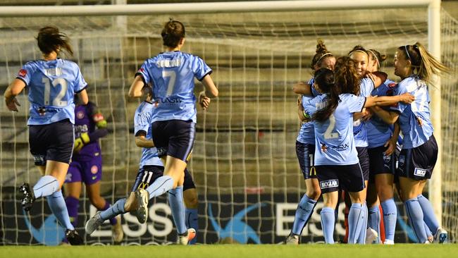 Caitlin Foord is mobbed by teammates after scoring for Sydney FC against the Wanderers at Marconi Stadium. Picture: AAP