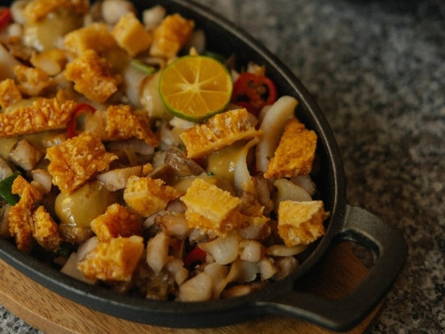 Sisig, a traditional Filipino sizzling pork dish, is made differently at Askal.