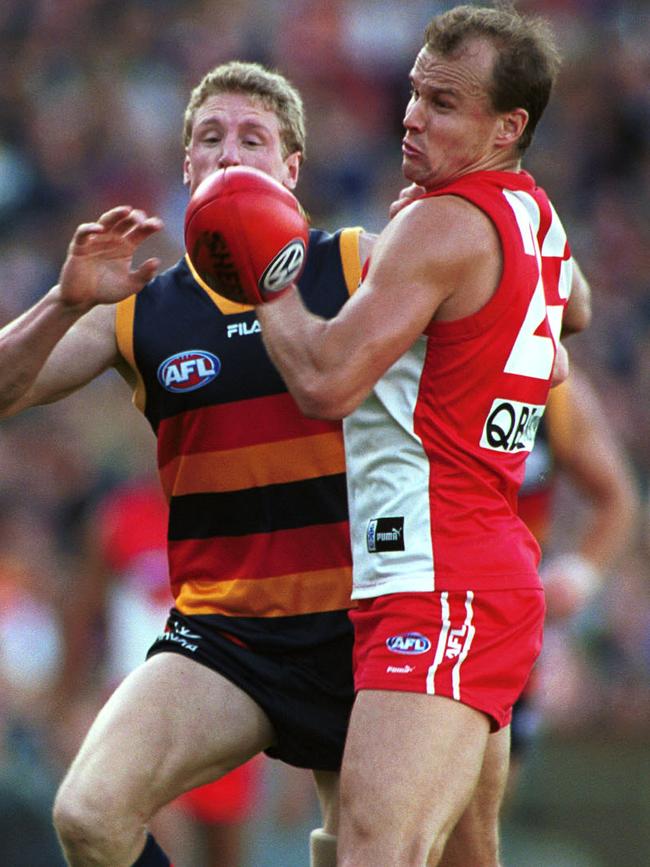 Matthew Nicks competes with outgoing Crows head of football Brett Burton during his Swans career.