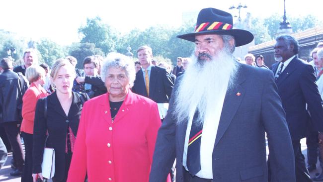 Aboriginal leaders Pat Dodson and Lowitja O'Donoghue walk by the gates of Buckingham Palace, London, after meeting the Queen in 1999.