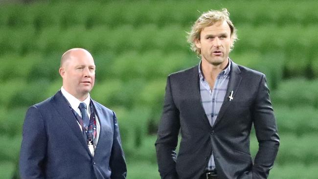 Former Rebels coach Tony McGahan chats with Crusaders mentor Scott Robertson.