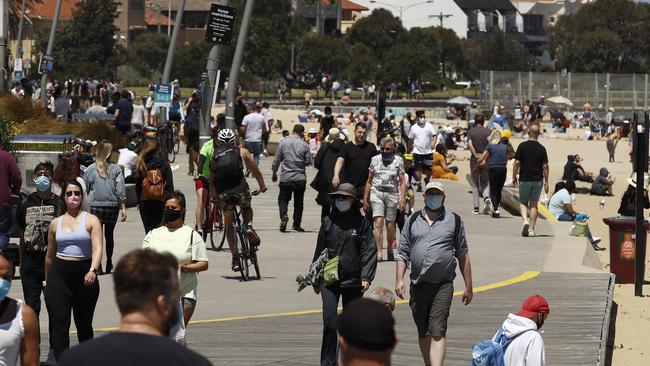 Masked Melburnians enjoy the weather at St Kilda beachyesterday. Picture: NCA NewsWire / Daniel Pockett