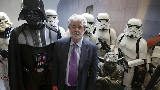 "Star Wars"creator George Lucas poses with characters from the movies "Star Wars".