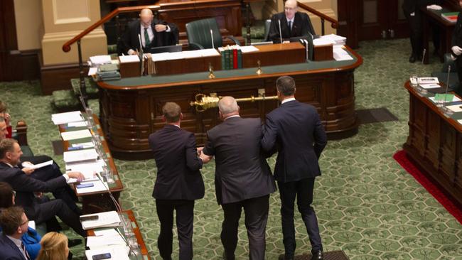 Leon Bignell is installed as speaker in the Lower House of Parliament in Adelaide, being dragged to the chair by the Premier and Opposition Leader. Picture: Brett Hartwig