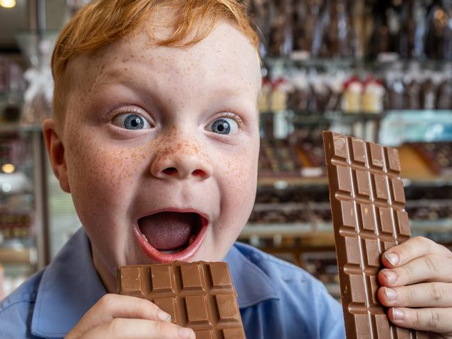 The cost of wholesale cocoa beans soared to the highest level in more than a decade, and manufacturers are betting prices of the key chocolate ingredient will stay elevated through 2024. Wilbur Arkeveld (6) enjoys a block of chocolate at Chocilo in Ivanhoe. Picture: Jake Nowakowski