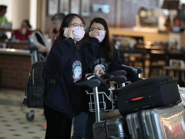 People arrive from Shanghai into Brisbane International Airport. Pic Peter Wallis