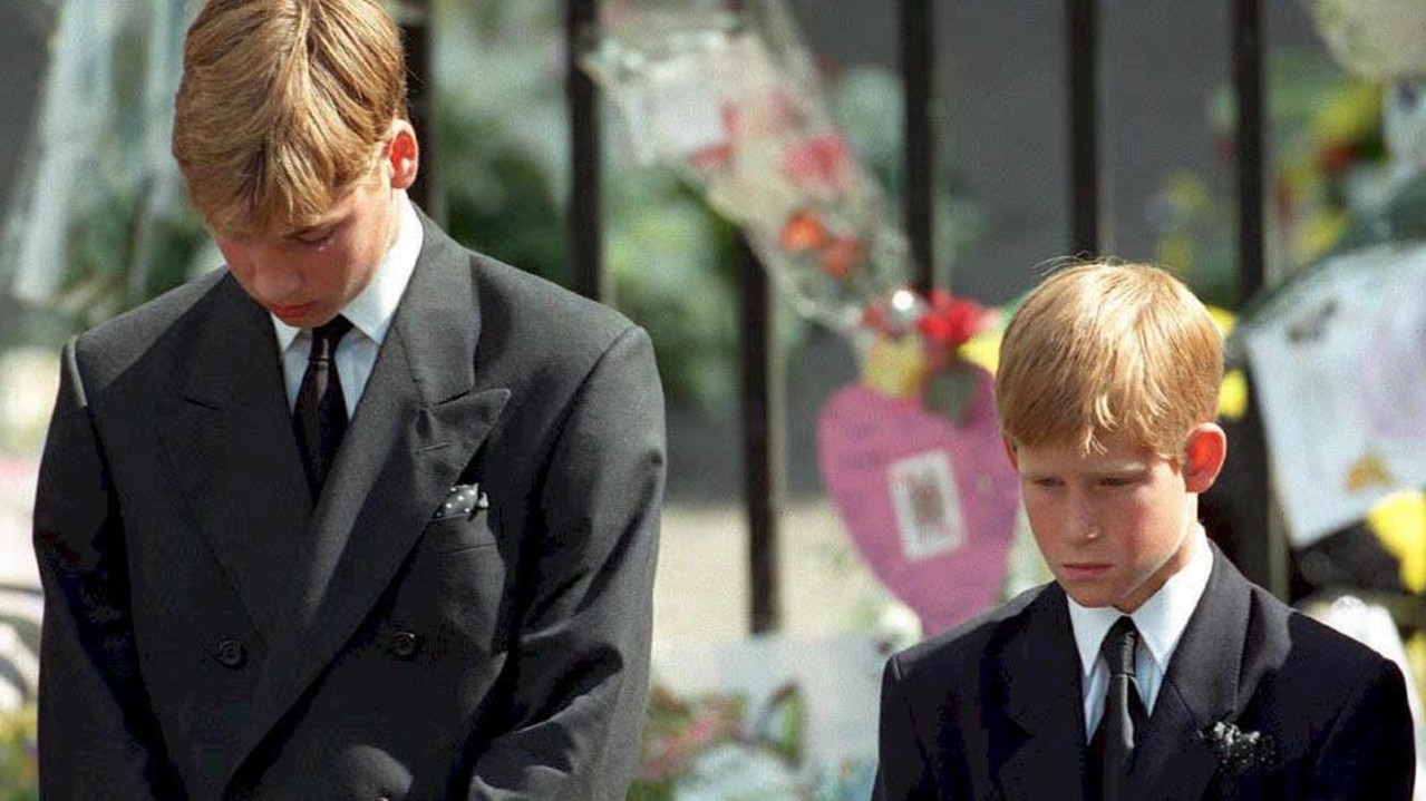 Prince William and Prince Harry bow their heads as their mother's coffin is taken out of Westminster Abbey. Picture: Adam Butler