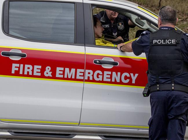 Smoke haze covers the Gold Coast Skyline  from a grass fire at Carrara. Emergency services at St Michael's Collage, Merrimac. Picture: Jerad Williams