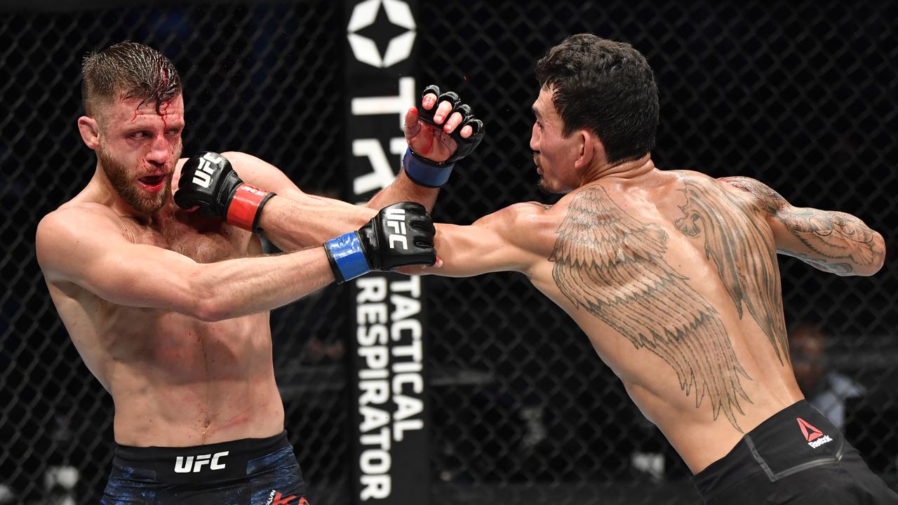 Max Holloway punches Calvin Kattar during their January bout. (Photo by Jeff Bottari/Zuffa LLC via Getty Images)