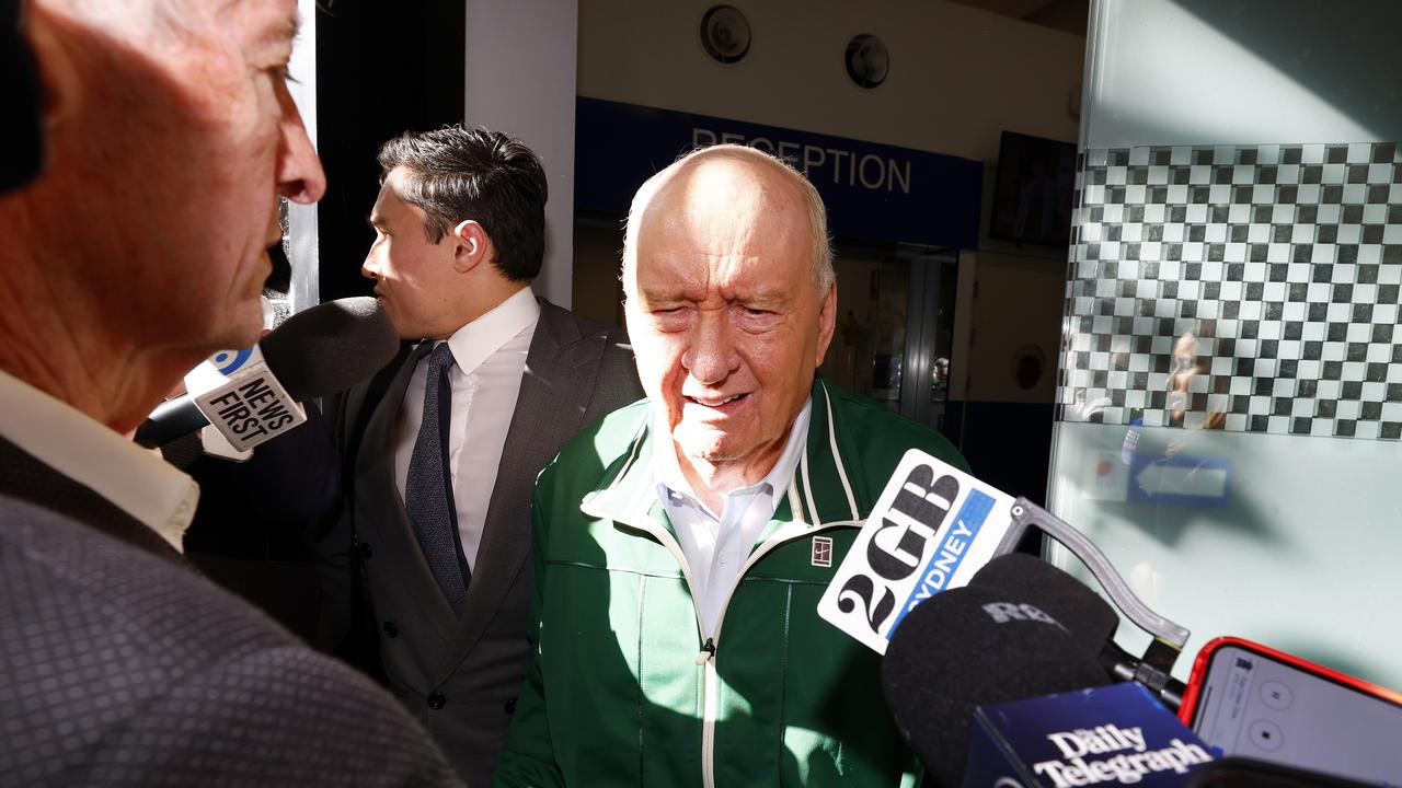 Alan Jones leaving Day Street Police Station with his lawyer Chris Murphy. Picture: Jonathan Ng