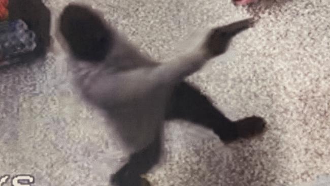 CCTV cameras captured a person in a black balaclava wielding what appeared to be a handgun in the alleged robbery at Liberty Cannonvale about 9.40pm on Sunday, December 12. Picture: Supplied