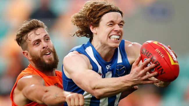 Kangaroos forward Ben Brown marks ahead of Giants defender Tim Mohr in Hobart on Saturday. Picture: Adam Trafford/AFL Media/Getty Images