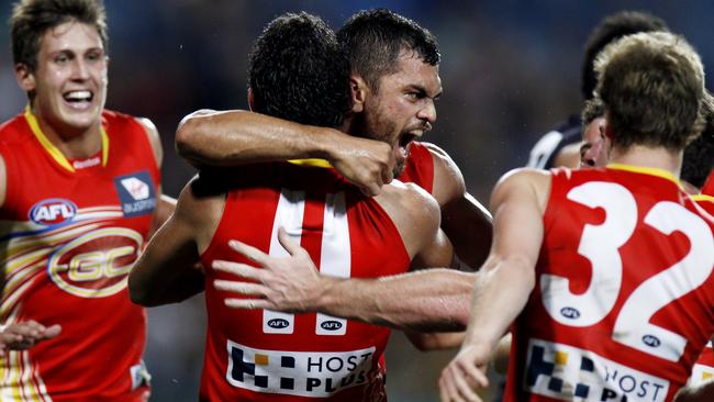 Hunt celebrates with teammates after kicking the winning goal against Richmond.