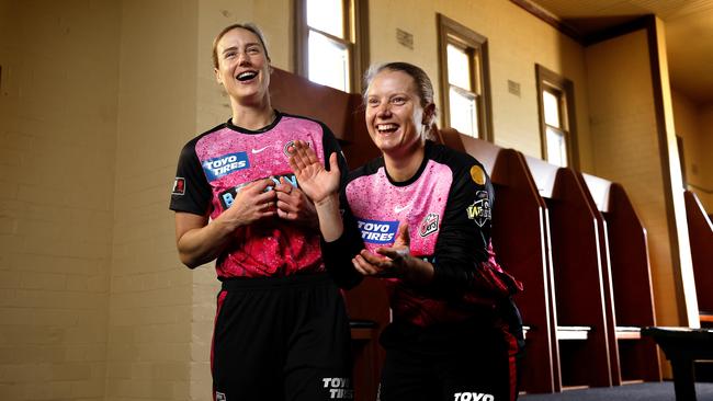 Perry and Healy re-enacting their photo from singing the NSW Breakers victory song from 2009, back in the Sydney Cricket Ground dressing rooms. Picture: Phil Hillyard