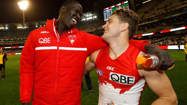 Aliir Aliir and Tom Papley celebrate the Swans 2016 preliminary final win over Geelong at the MCG. Aliir injured his knee and missed the grand final against the Western Bulldogs.