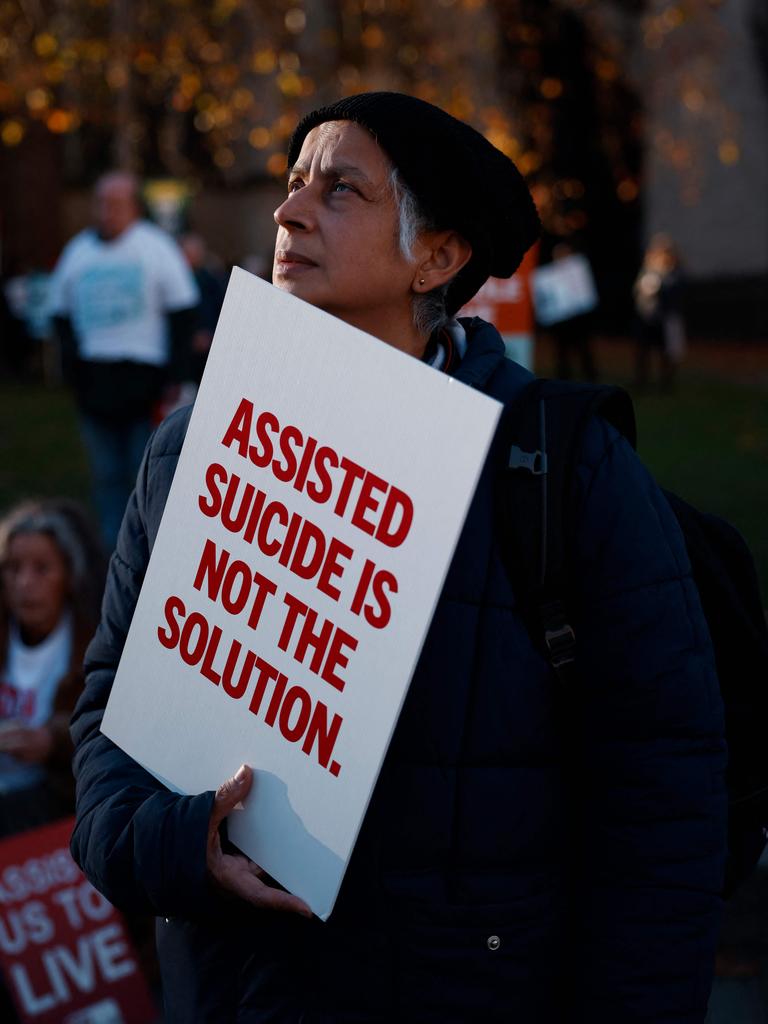 A campaigner against the assisted suicide bill holds a placard at a demonstration outside The Palace of Westminster. Picture: Benjamin Cremel/AFP