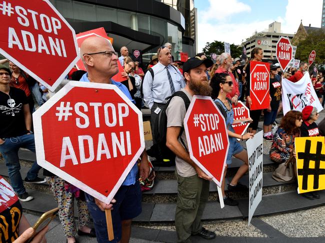 Protestors against the Adani coal mine rally outside Adani's headquarters in Brisbane, Friday, October 20, 2017. The protestors are trying to stop the building of Adani's proposed Carmichael mine in Queensland. (AAP Image/Darren England). NO ARCHIVING