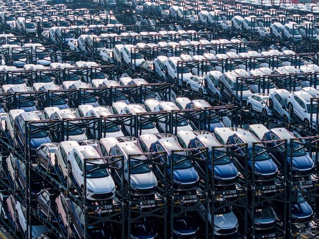 (FILES) BYD electric cars wait to be loaded onto a ship are seen stacked at the international container terminal of Taicang Port in Suzhou, in Chinaâs eastern Jiangsu province on February 8, 2024. Shares in Chinese automaker BYD jumped on February 11, 2025 after it unveiled plans to unroll advanced self-driving technology on nearly all its cars, including budget models priced below 10,000 USD. (Photo by AFP) / China OUT