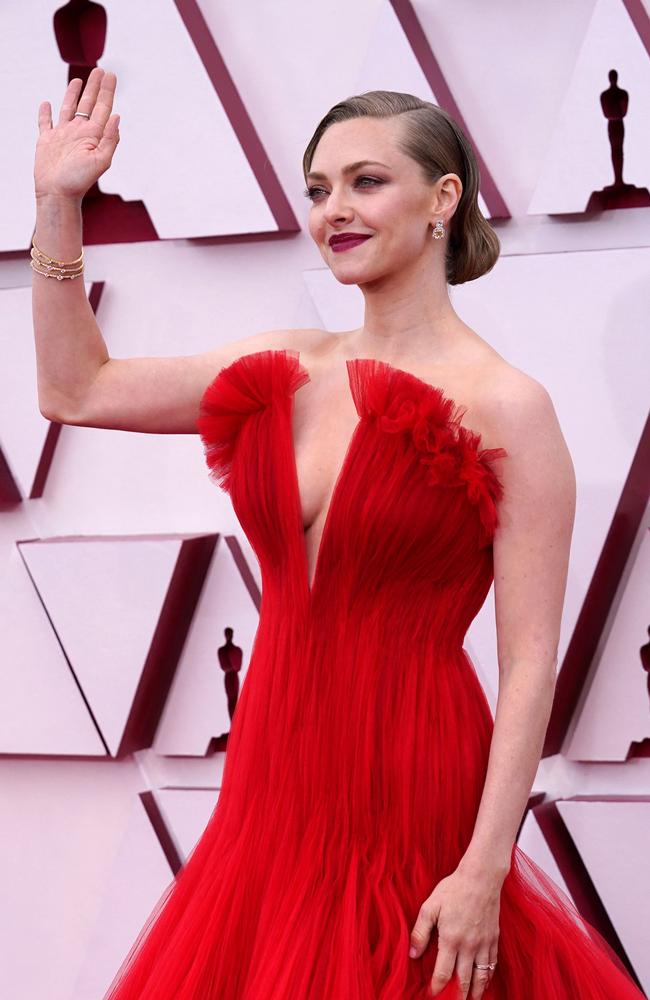 Seyfried wore a plunging red gown. Picture: Chris Pizzello / POOL / AFP