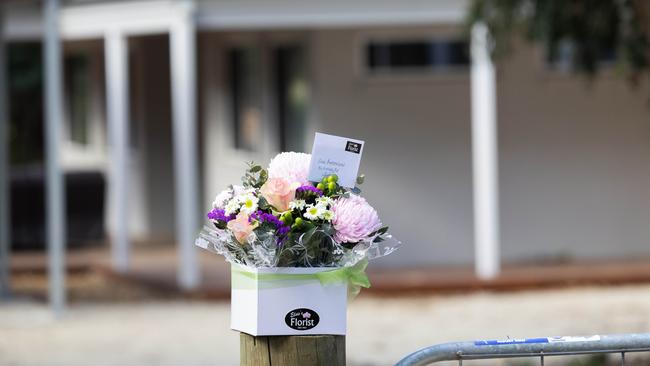 Flowers have been left at the front of her home. Erin Patterson arriving at her Leongatha home after three people died eating Death Cap mushrooms from a meal she had cooked. Picture: Jason Edwards