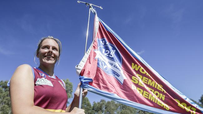 Marcellin captain Al Rock with last season’s premiership flag. Picture: Valeriu Campan