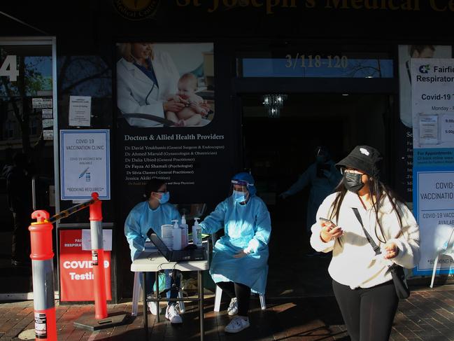 Medical staff assist people queuing at a medical centre to undertake COVID-19 testing in the district of Fairfield. Face masks are mandatory outdoors in the LGA. Picture: Getty