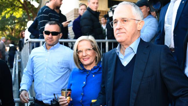 Malcolm Turnbull and wife Lucy leave a polling station after casting their votes.