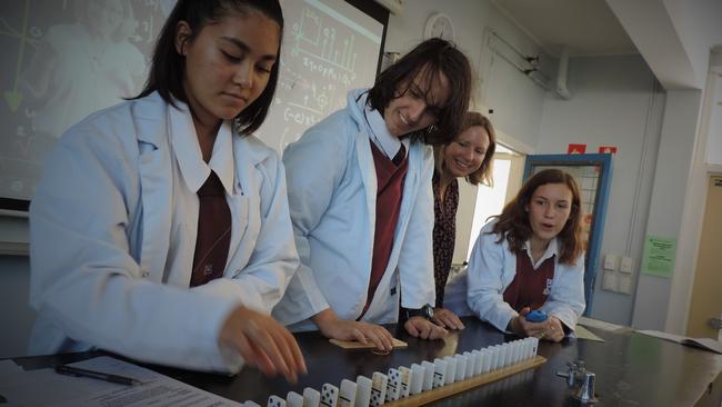 Wavell State High School science teacher Rachel Schnitzerling (2nd from right) overseas a science experiment by Year 10 students Attalia Lagoudakis, Sean Nicolas and Chloe Todd.