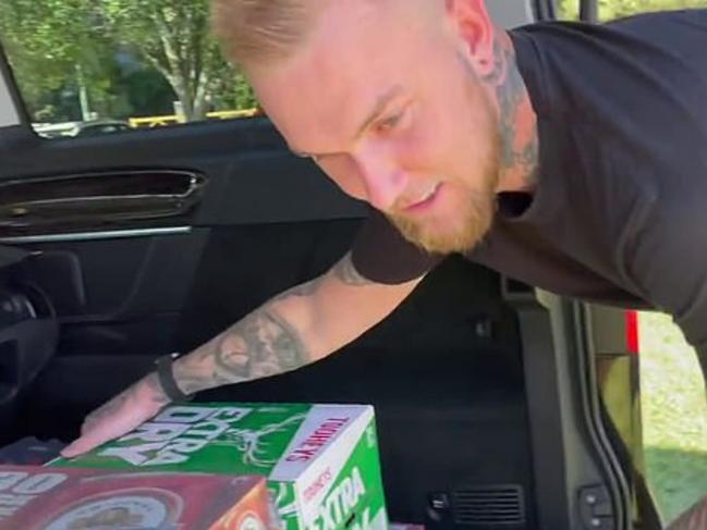 Erwin handing out the beer at the protest. Picture: YouTube