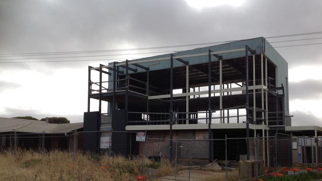 An unfinished house at 9 Gold Coast Drive, Carrickalinga is a beachfront blight which residents want demolished.