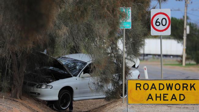 A man with a gunshot wound to his face was found near a car that crashed into a tree at Waterloo Corner. Picture: AAP/Russell Millard