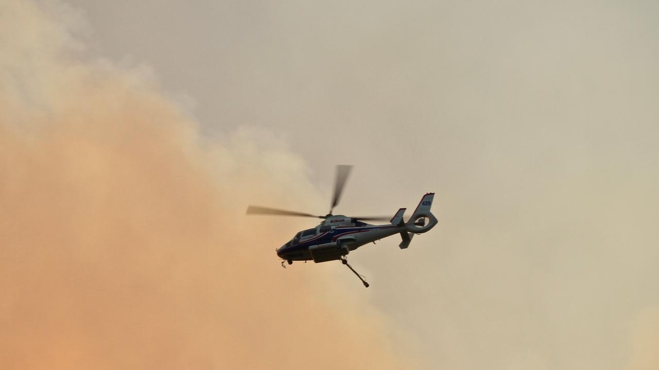 Water bombing helicopters will be deployed to bushfire zones across Queensland today. Picture: Jacob Friend