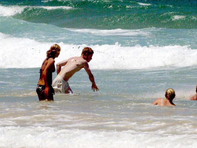 Prince Harry takes a swim at Noosa Beach during his visit to Australia in 2003.