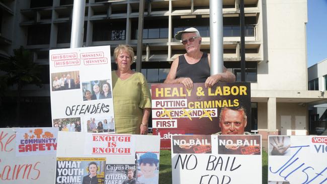 Anti-crime advocates Humphrey Hollins and Perri Conti have erected protest corflutes outside the Cairns Court House complex on Sheridan St demanding action on youth crime from the state government. Picture: Peter Carruthers