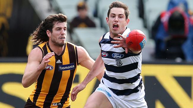 Daniel Menzel taps the ball away from Ben Stratton. Picture: Michael Klein