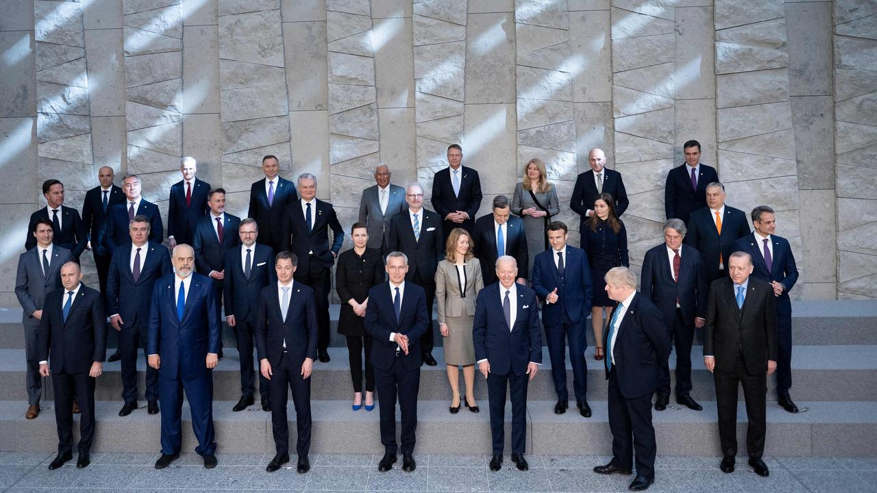 Britain's Prime Minister Boris Johnson (2R) looks at US President Joe Biden (3R) while posing for a family photograph with NATO Secretary General Jens Stoltenberg (C), Turkey's President Recep Tayyip Erdogan (R) and other leaders as they pose for a family photograph. Picture: Brendan Smialowski / AFP