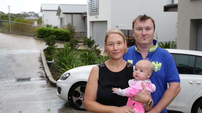 Andrew and Karen Plunkett and baby Charlotte on their street where houses could be acquired.