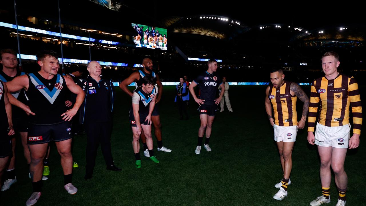 Ken Hinkley exchanges words with Hawthorn players after a famous semi final. Picture: Michael Willson/AFL Photos via Getty Images.