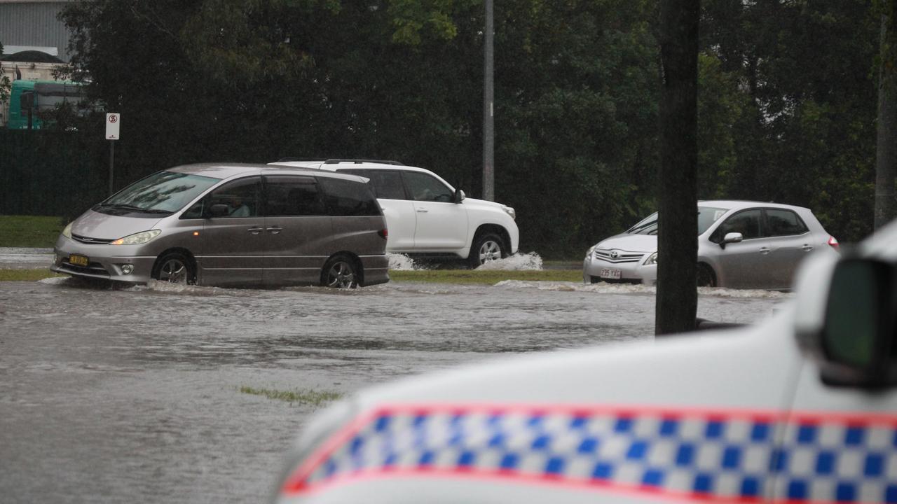 Cars drive through rising floodwaters on the southern end of the Gold Coast. Picture: Mike Batterham