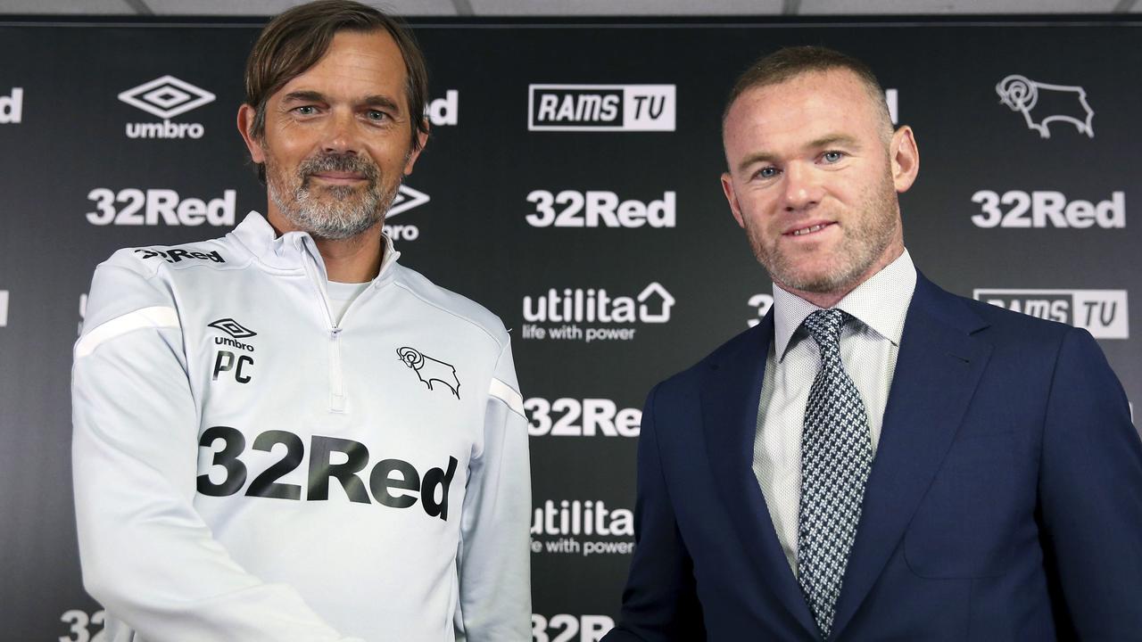 Derby County manager Phillip Cocu shakes hands with Wayne Rooney.