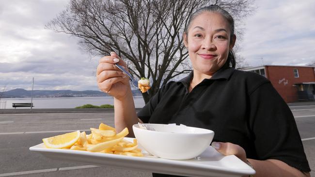 Manning reef cafe staff member Titim Wahyuni with some of Manning Reef's Tasmania Scallop dishes.