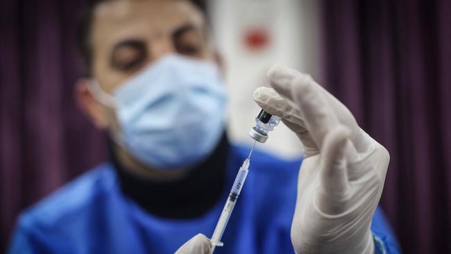 A medic prepares to administer Pfizer vaccine. Picture: AFP