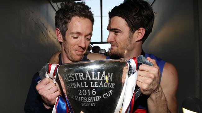 Western Bulldogs captain Bob Murphy and stand-in skipper Easton Wood with the 2016 premiership cup. Picture: Michel Klein